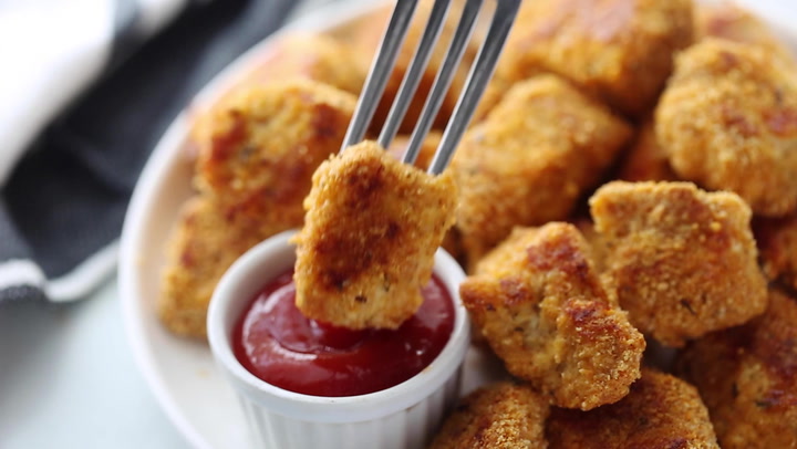 Golden gluten-free chicken nugget ready for dipping
